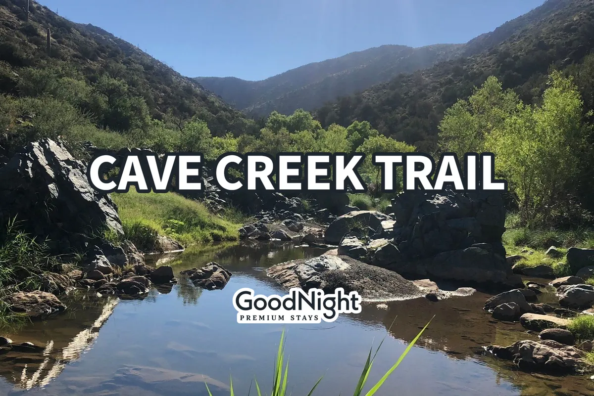 A scenic creek winds through rock formations and lush desert vegetation, with distant mountains framing the background. The area is tranquil, ideal for hiking, nature walks, photography, and bird watching. The natural landscape is inviting, highlighting the beauty of Cave Creek's outdoors.