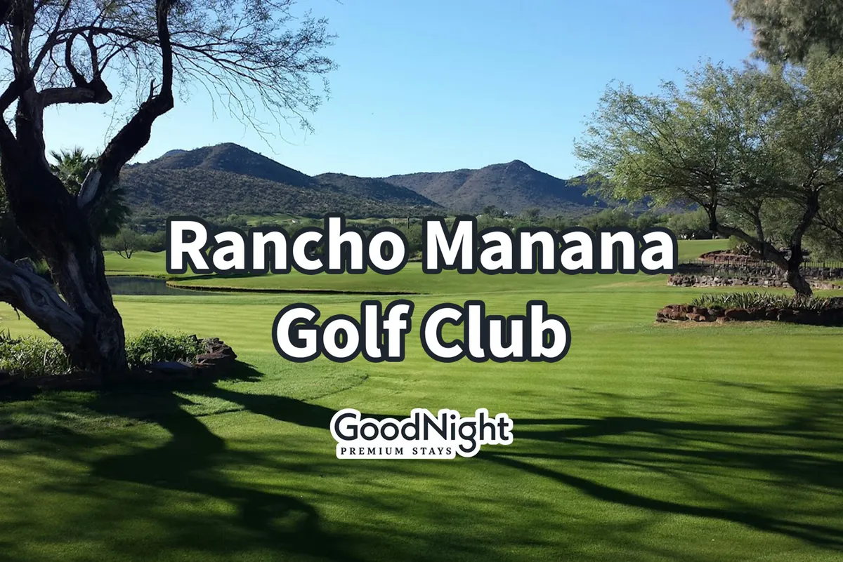 A beautifully maintained golf course stretches out with lush green grass, dotted with trees and sand traps, set against a majestic mountain backdrop. The tranquil scene is perfect for golfing, picnicking, or leisurely nature walks, with stunning scenic views all around.